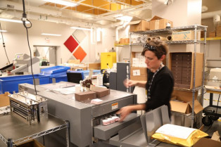 Misti Muller slits business cards on the in-plant&rsquo;s Duplo 645 slitter/cutter/creaser.