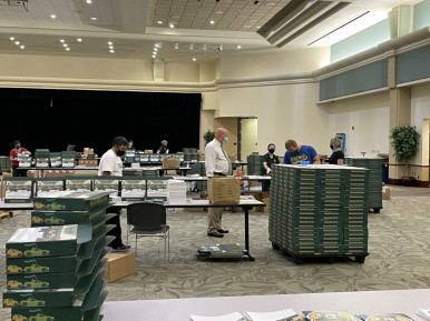 Fulfillment has been a great new service for Sacramento State&rsquo;s in-plant to offer. Here, Reprographics Specialist Mike Garden (blue shirt) wraps a pallet of &ldquo;CARmencement&rdquo; boxes while President Robert S. Nelsen looks on.