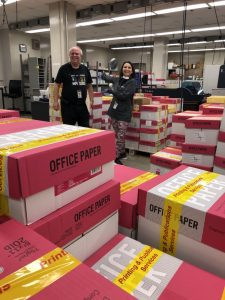 Steve Priesman, manager of Omaha Public Schools Printing & Publications Services, and Donna Dobson, director of elementary education, celebrate the completion of 24,000 student packets printed by the in-plant, ranging from 40 to 90 pages in length.