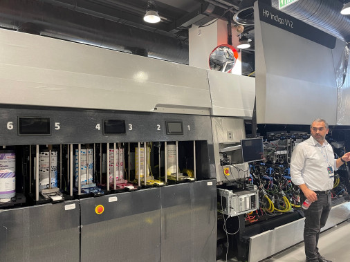 Roi Liraz, lead system engineer at HP Indigo, stands with the new HP Indigo V12 digital press.