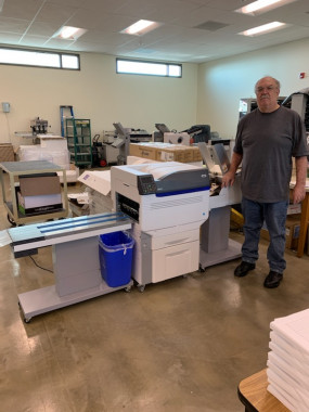 lDennis Winters stands with Printing and Graphics Services&rsquo; new OKI C931E digital envelope press, which has improved the quality of the in-plant&rsquo;s envelope printing. 