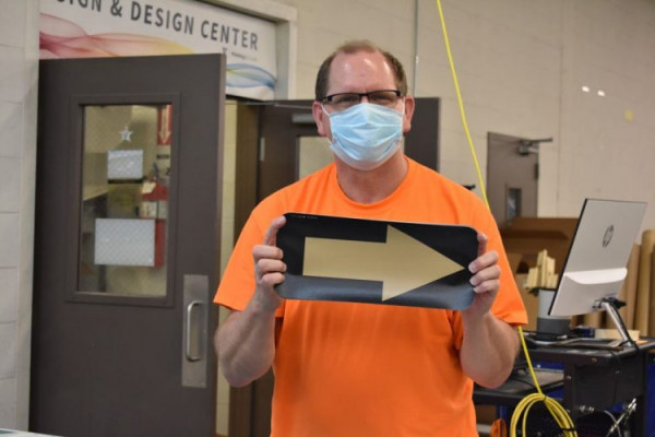 Vanderbilt University Printing Services employees print directional signage for university buildings.