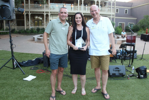 Accepting the award for the best case study for the transaction segment was Tonya Powers (center) of Canon Solutions America. Awards were presented by David Pesko (left) and Marco Boer.